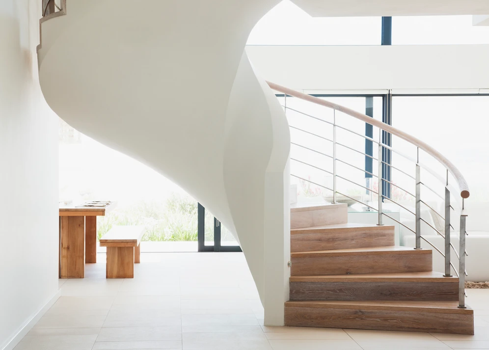 A modern home's spiral staircase, an architectural marvel, adds elegance and functionality to the interior. A modern home's spiral staircase, an architectural marvel, adds elegance and functionality to the interior.